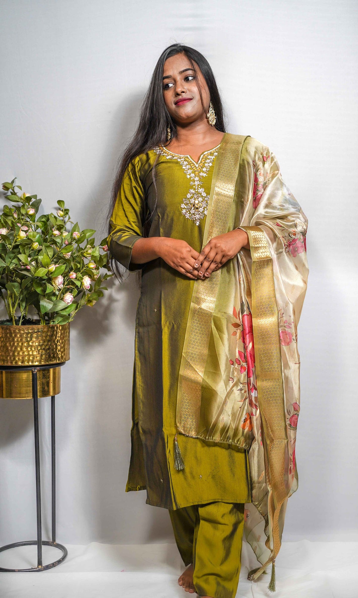 This is a gorgeous festive piece — that olive-green silk with the embroidered yoke and the floral Banarasi dupatta is very Puja-ready