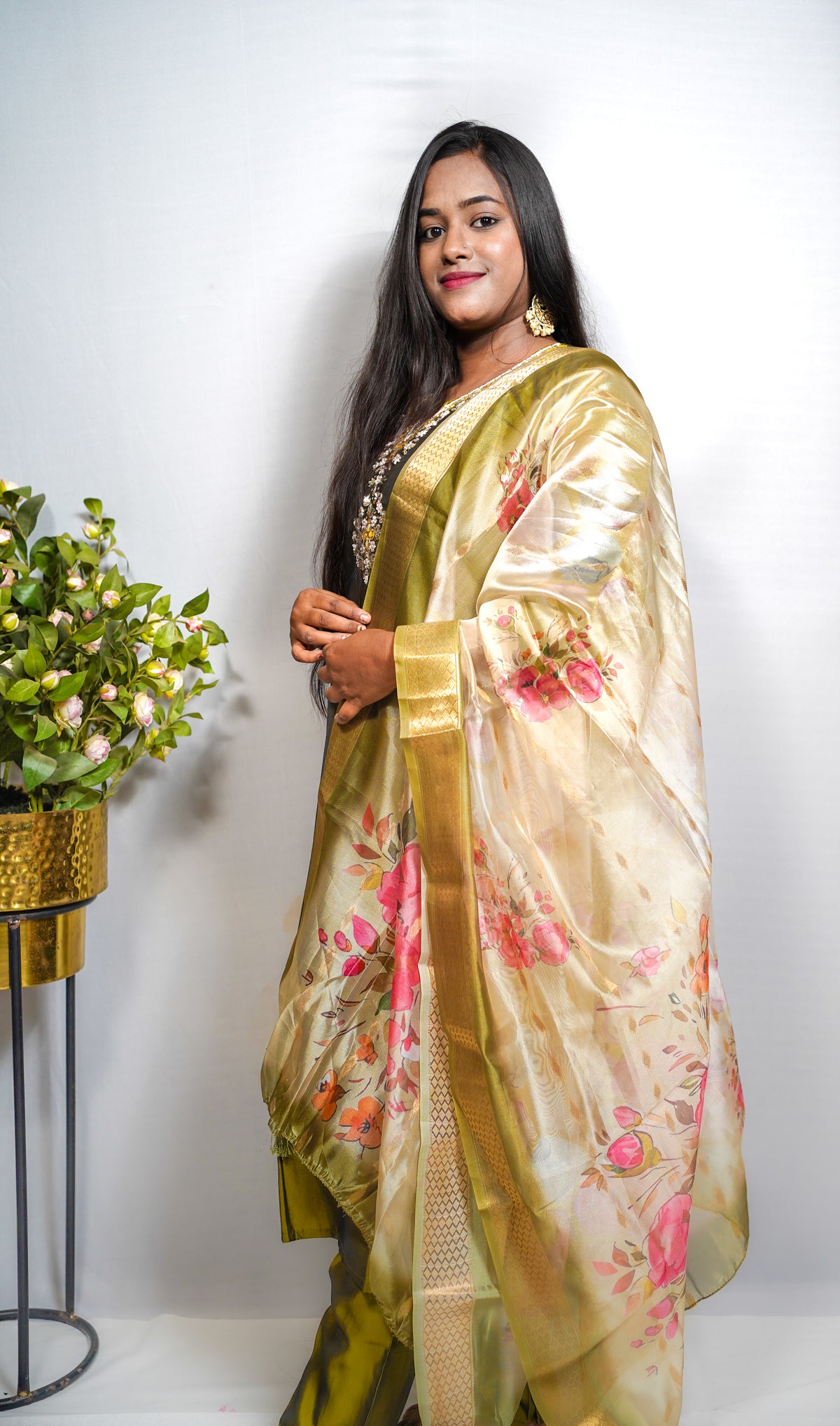 This is a gorgeous festive piece — that olive-green silk with the embroidered yoke and the floral Banarasi dupatta is very Puja-ready