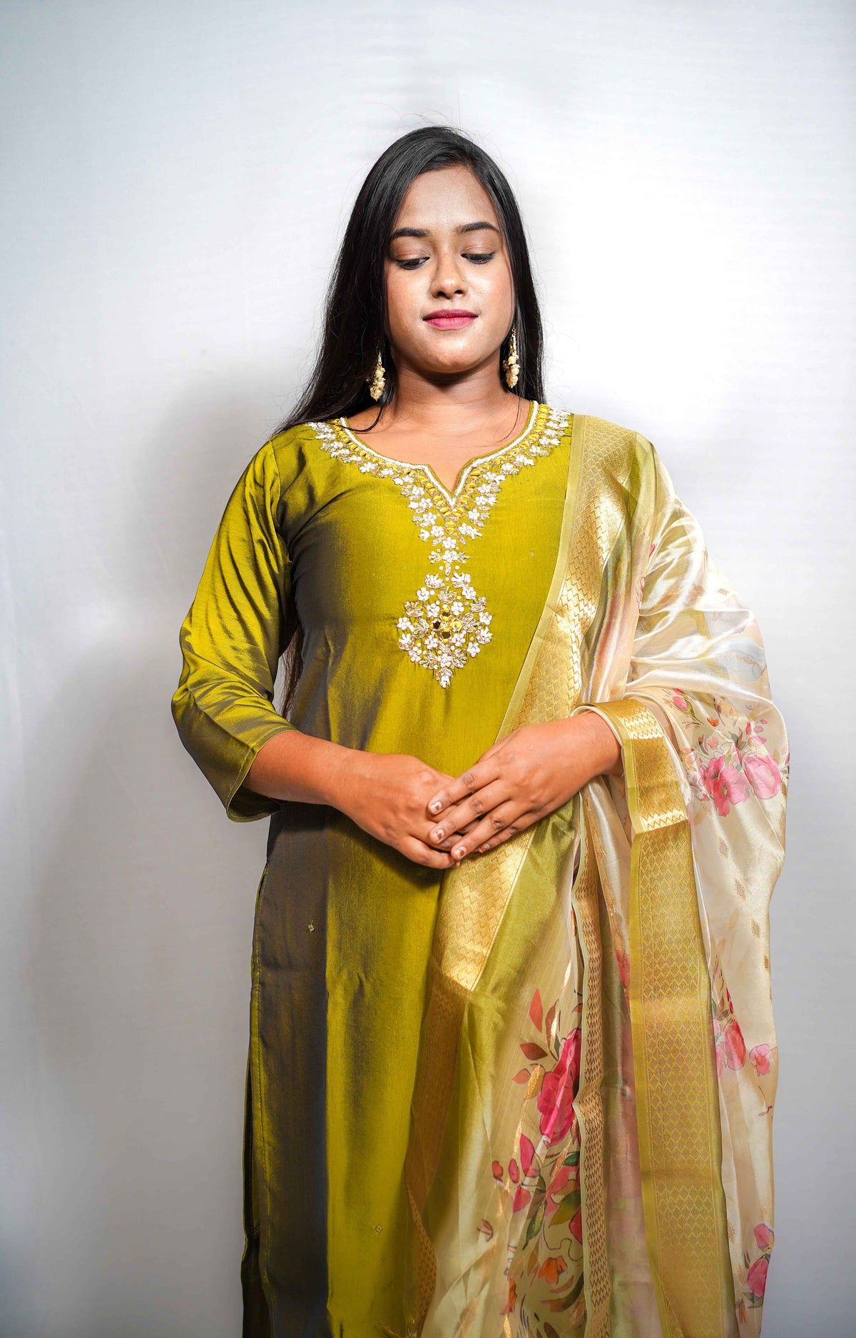 This is a gorgeous festive piece — that olive-green silk with the embroidered yoke and the floral Banarasi dupatta is very Puja-ready
